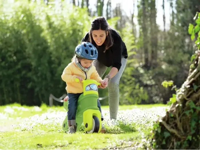 Green Motorcycle toddler ride-on with leaf motif promoting coordination and gross-motor growth.