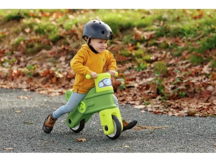 Green Motorcycle polyethylene ride-on with wide wheelbase supporting safe steering and confidence building.