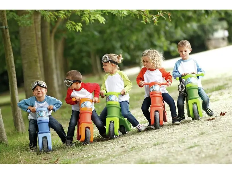 Motorcycle ride-on set for toddlers developing balance, coordination, and strength through active group play.