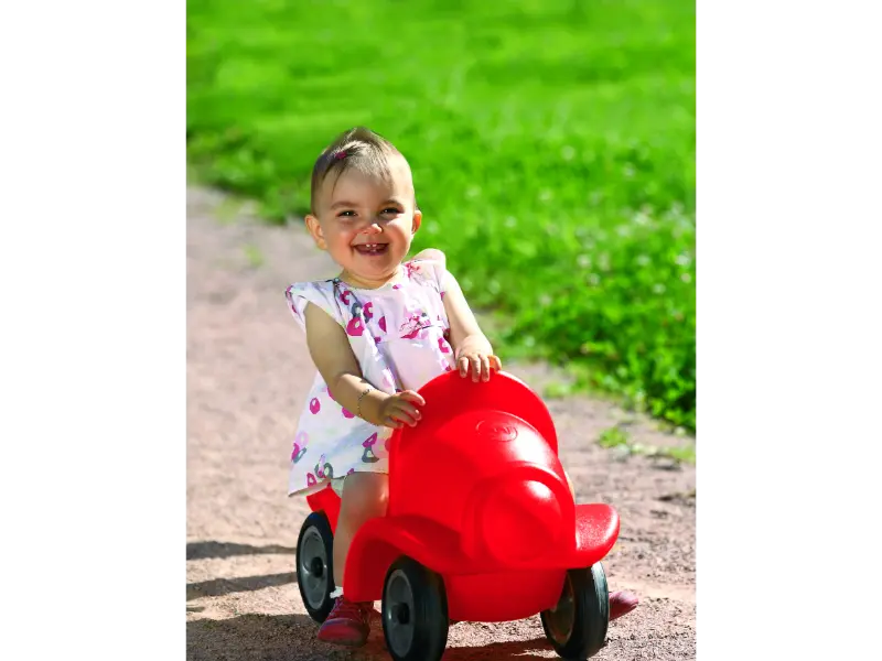 Rapido red toddler ride-on with front-wheel steering that builds mobility, stability, and gross motor skills.