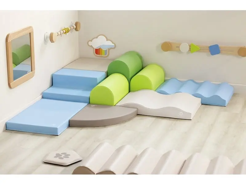 cushioned corner play area offering tactile exploration, stability practice, and calm sensory engagement