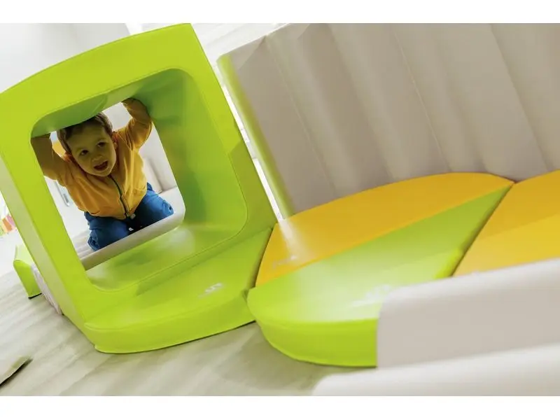 curved foam tunnel designed for active play and sensory discovery through safe, imaginative movement