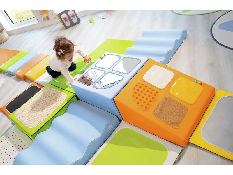 toddler sensory area with foam steps, slopes, and platforms supporting crawling, coordination, and open-ended physical play