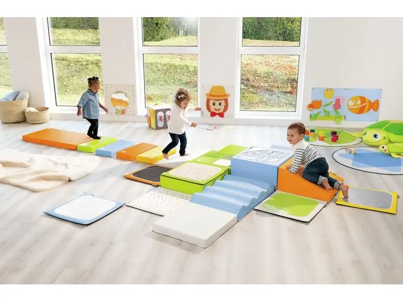 sensory play room setup featuring soft foam climbing pieces and balance elements arranged for early movement and exploratory play